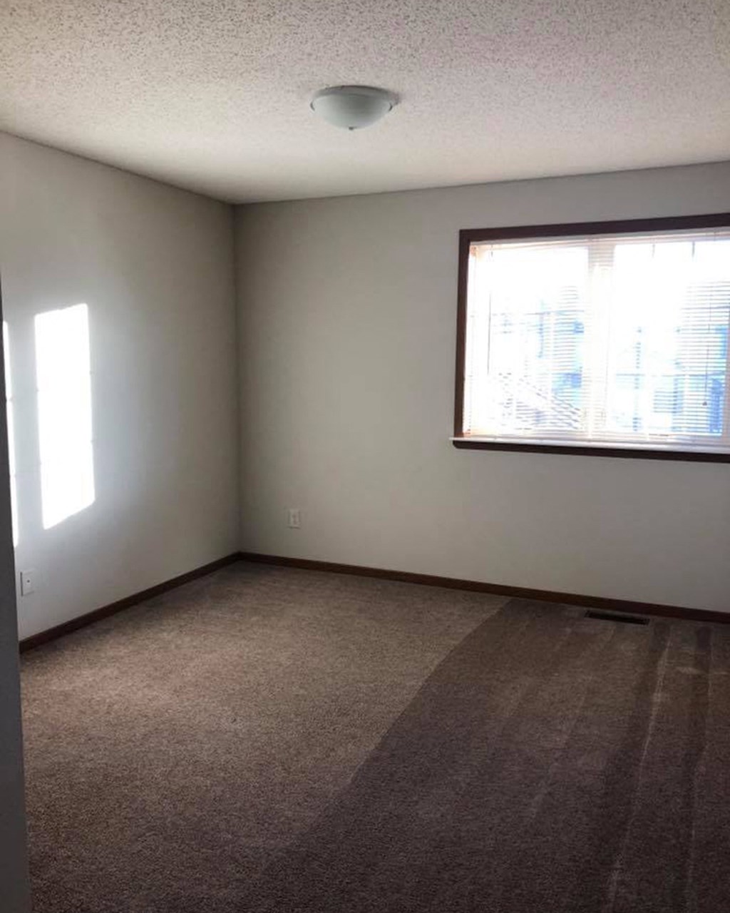 an empty living room with a large window