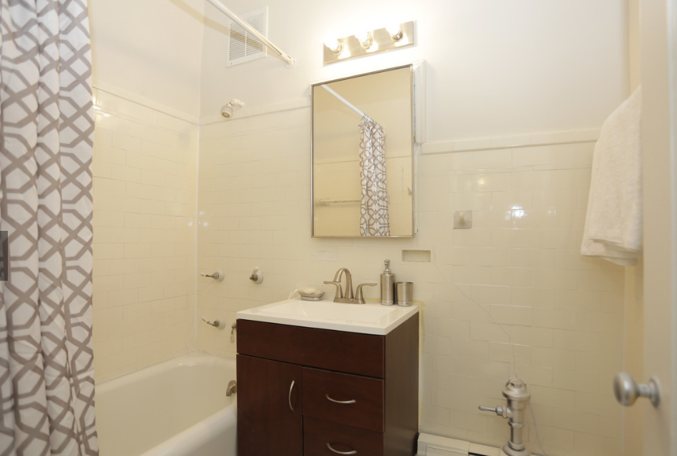 a small bathroom with a sink and a bath tub