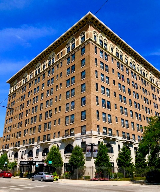 a large brick building on the corner of a street