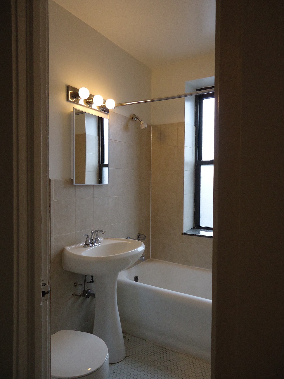 a bathroom with a sink and a bath tub and a window