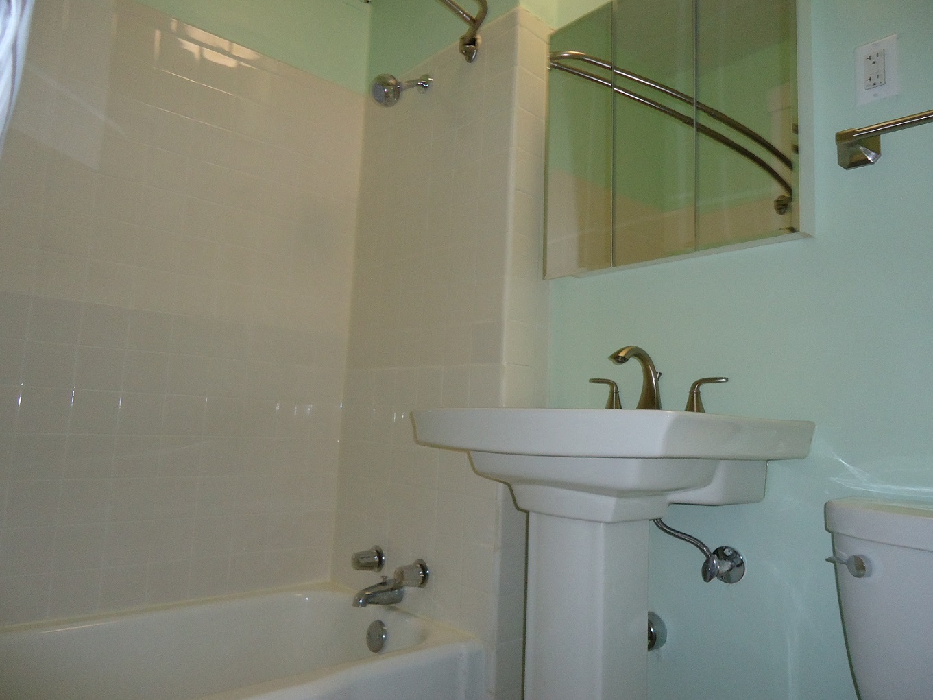 a bathroom with a sink and a tub and a mirror