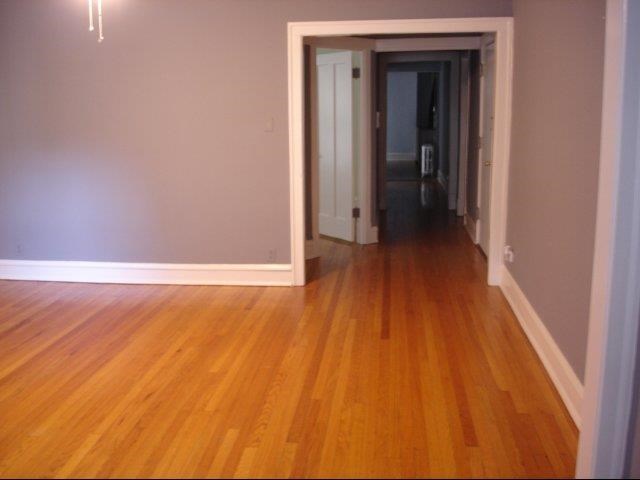 a living room and hallway with wood floors