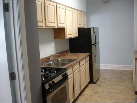 a small kitchen with a stove and a refrigerator