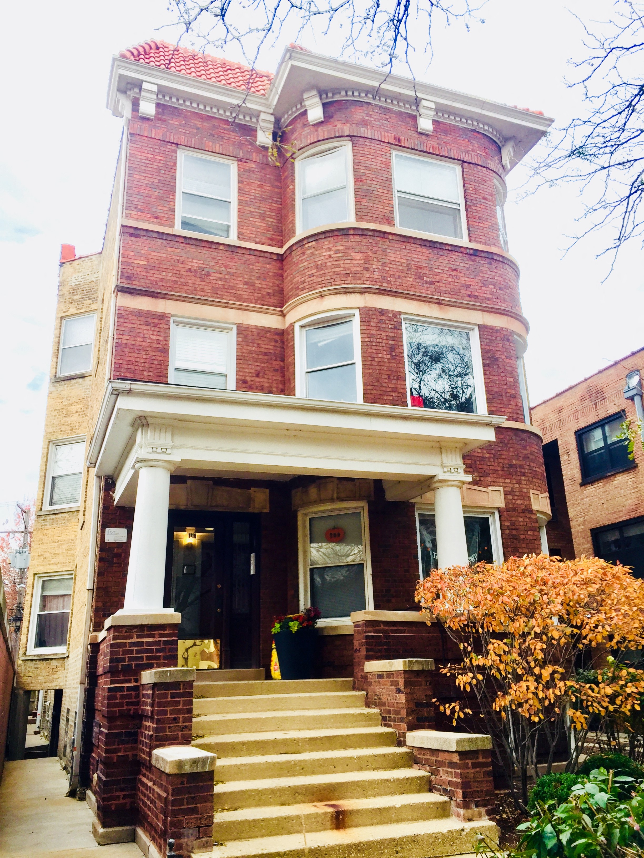 a red brick house with stairs in front of it