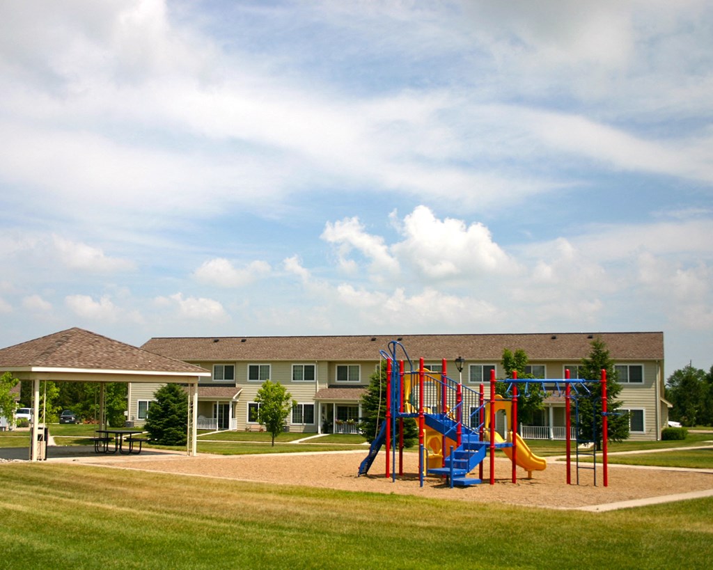 a playground with a building in the background