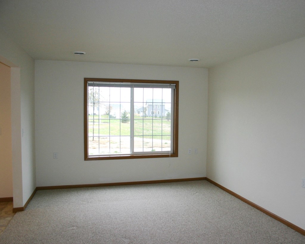 an empty living room with a large window