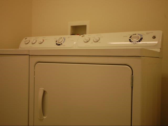a white stove top oven sitting on top of a refrigerator