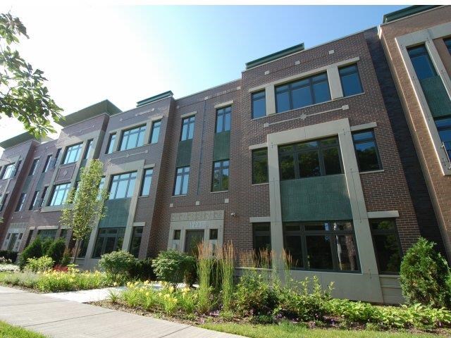 a large brick building with a sidewalk in front of it