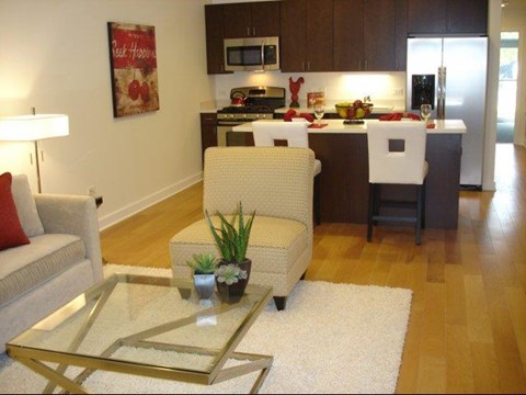 a living room with a kitchen and a table