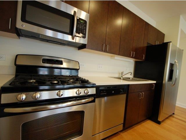 a kitchen with stainless steel appliances and a microwave