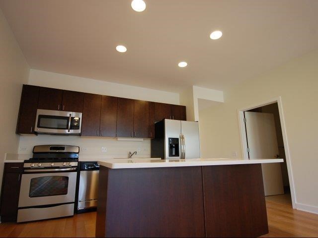 a kitchen with stainless steel appliances and a white counter top