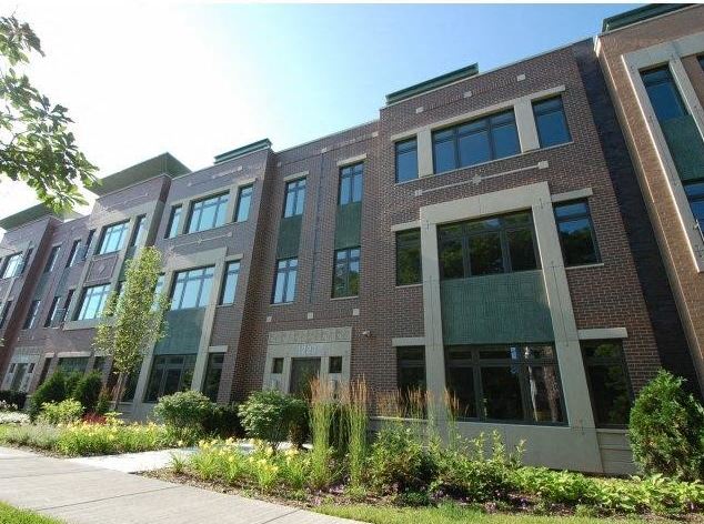 a brick building with a sidewalk in front of it