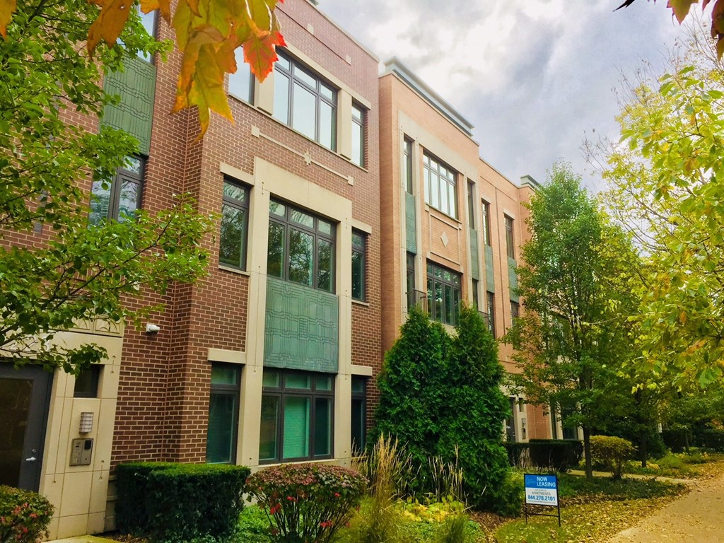 a brick building with a sidewalk in front of it