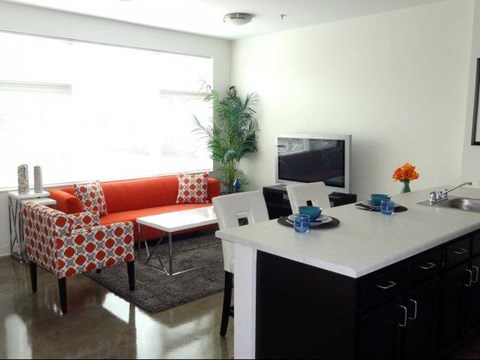 a living room with an orange couch and a table
