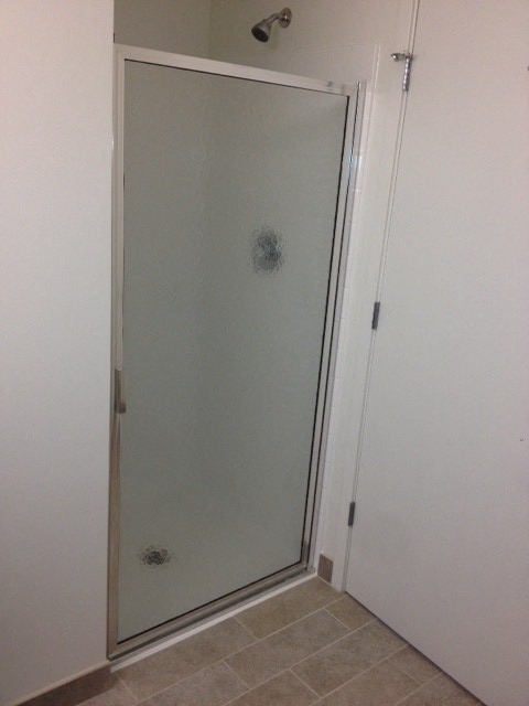 a shower with a glass door in a bathroom
