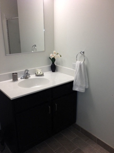 a bathroom with a white sink and a mirror