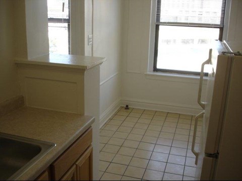 an empty kitchen with a sink and a window