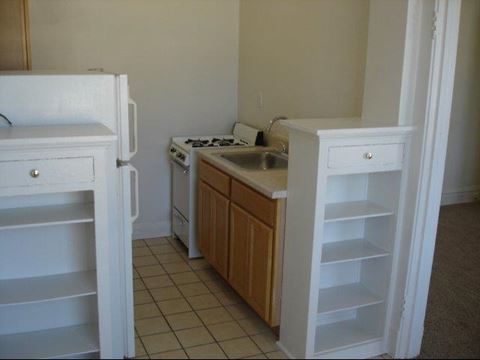a kitchen with a sink and a stove and a refrigerator