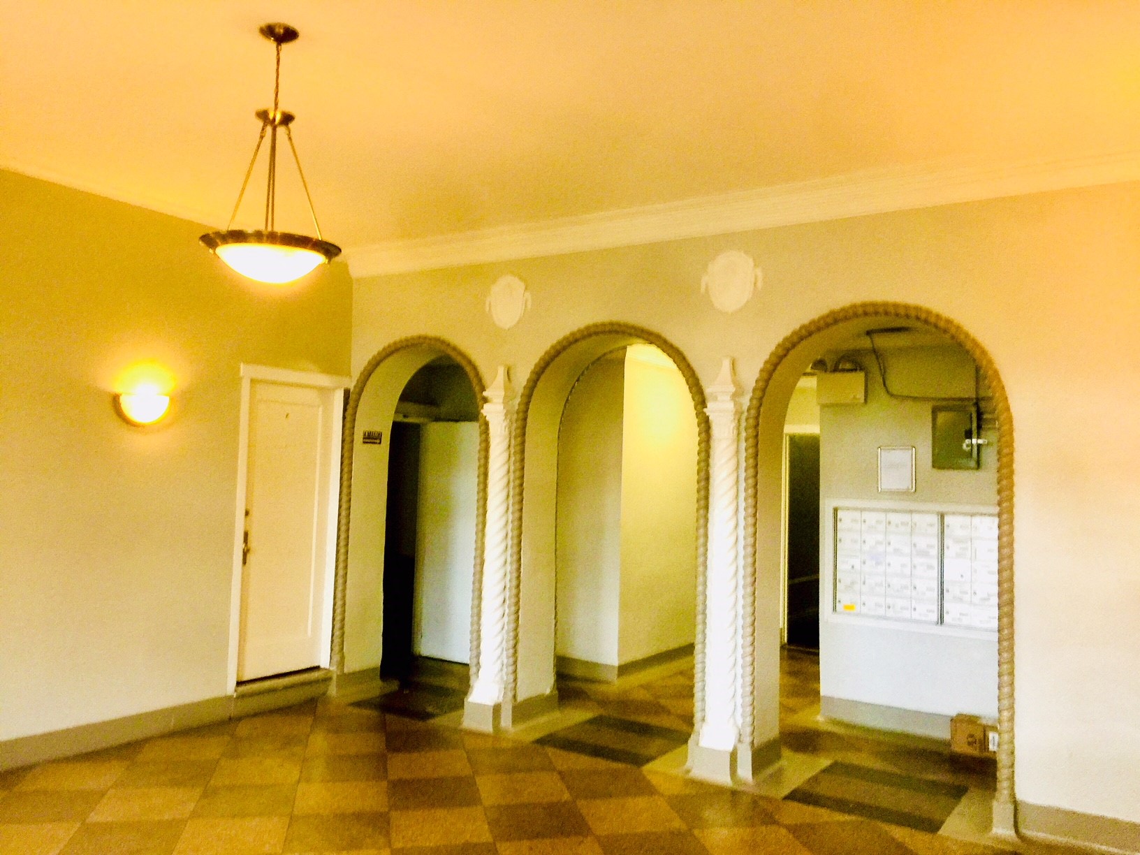a large room with arched doorways and a checkered floor