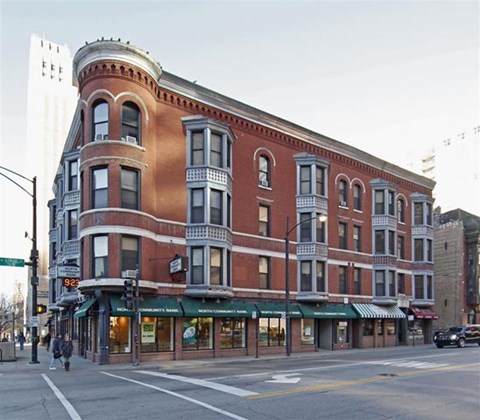 a large brick building on the corner of a city street