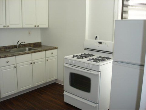 a kitchen with a stove and a refrigerator