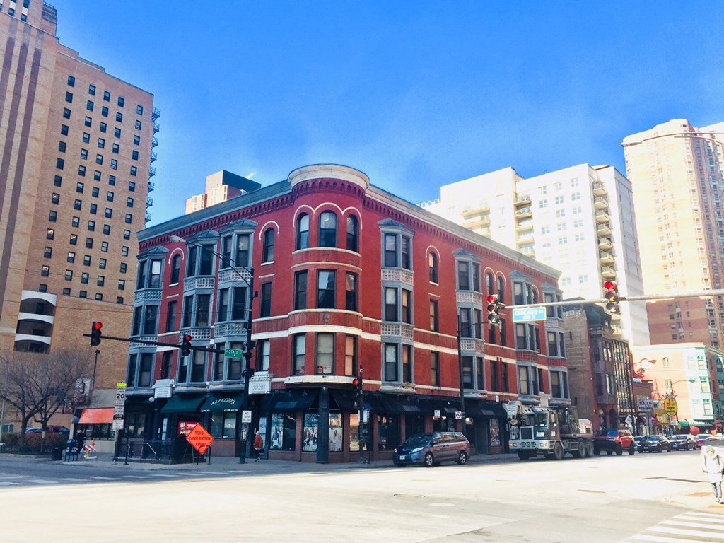 a red building on the corner of a city street