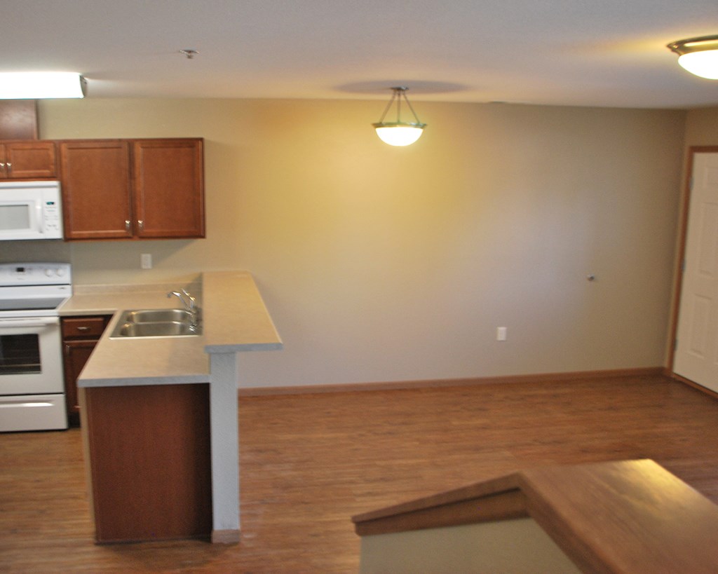 an empty kitchen with an island in the middle of it