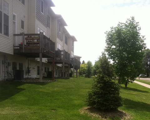 a view of the back of a house with a deck