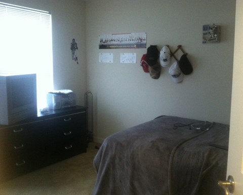 a bedroom with a bed and a dresser in it