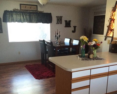 a kitchen and dining room with a table and chairs