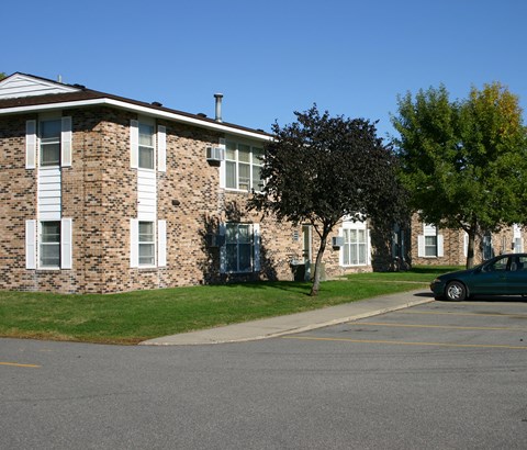 a large brick apartment building with a street in front of it