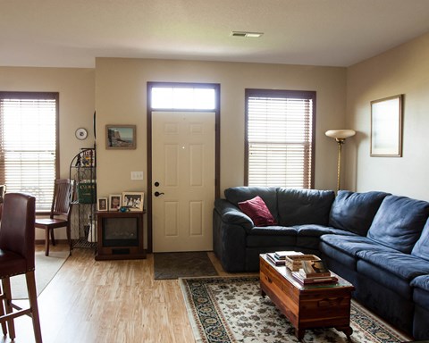 a living room with a blue couch and a coffee table