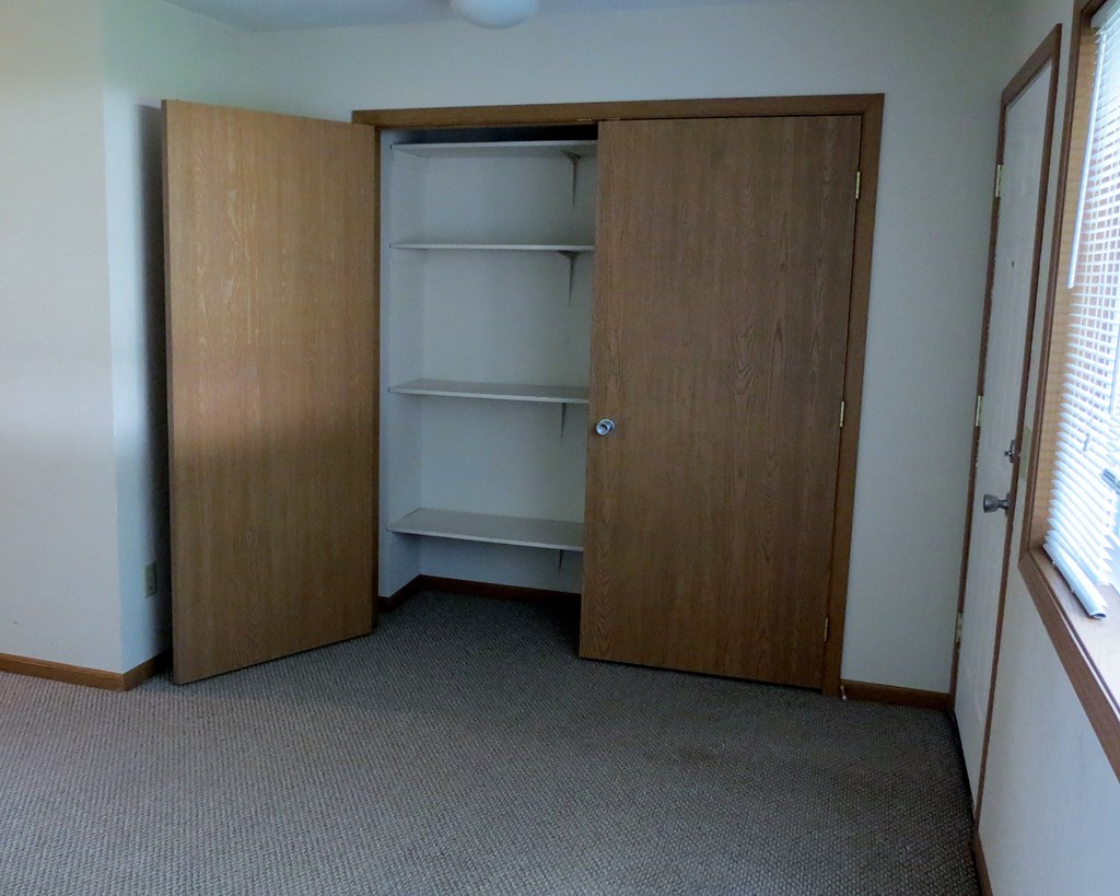 a room with a closet and a window