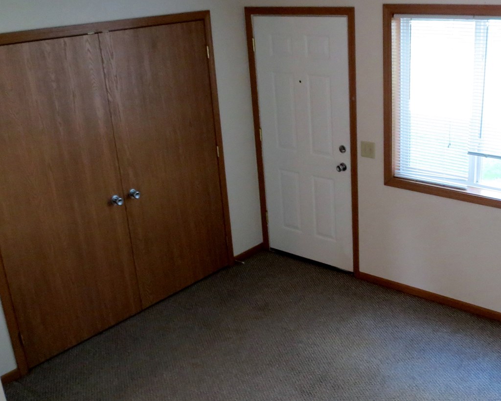 a bedroom with a door and a window