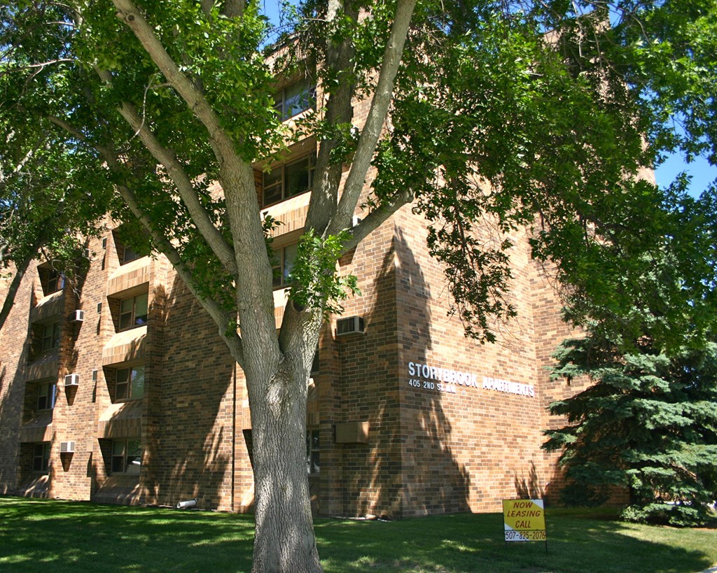 a brick building with a tree in front of it