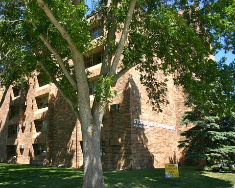 a brick building with a tree in front of it