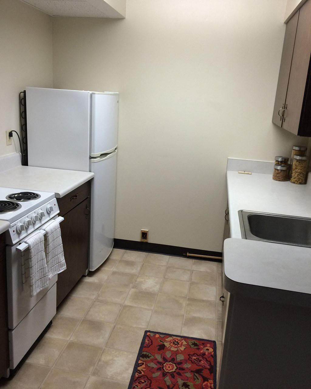 a kitchen with white appliances and a white refrigerator