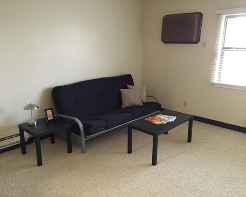 a living room with a couch and two tables