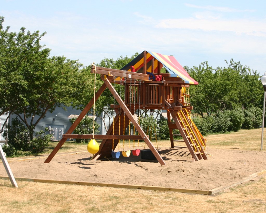 a swing set in a backyard playground