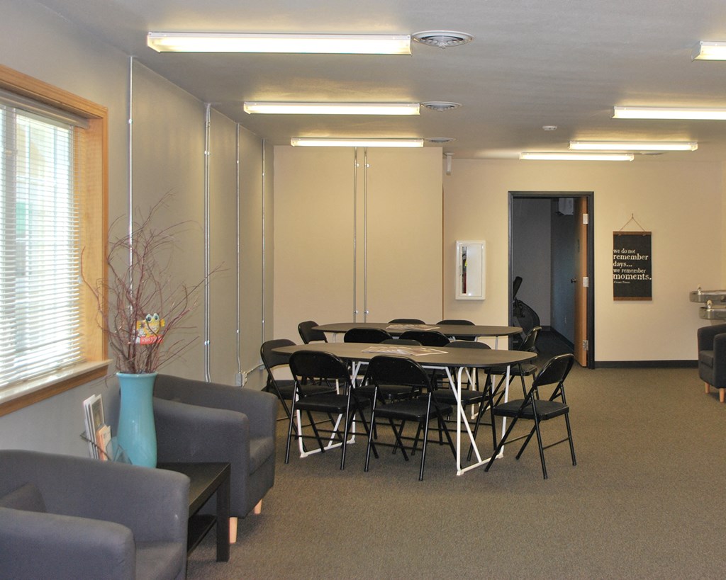 a conference room with a table and chairs in it
