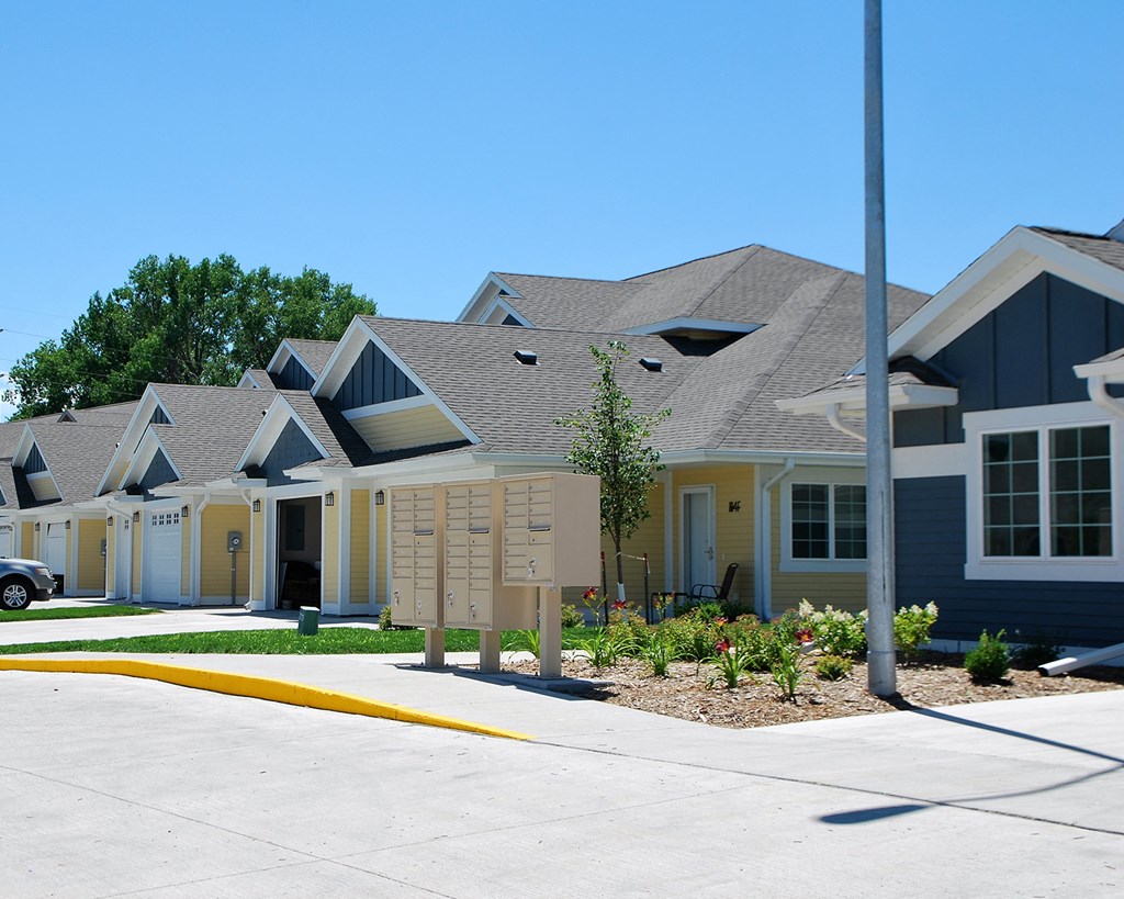 a row of houses with a street sign in front of them