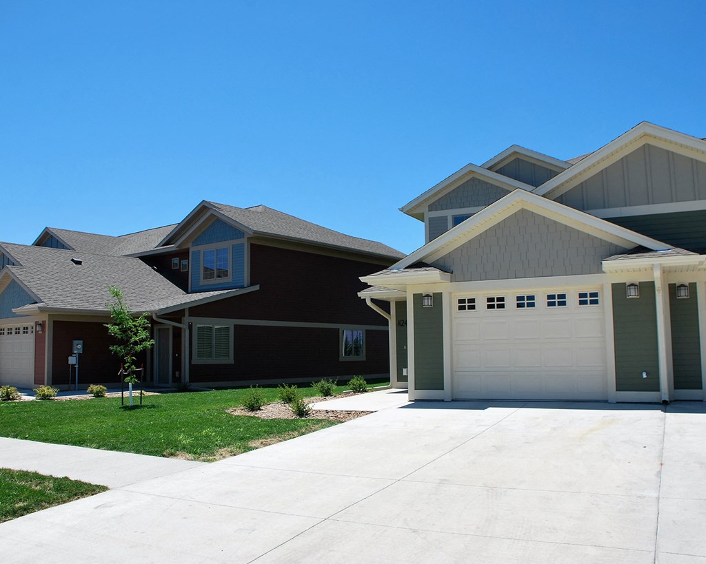 a house with a garage and a driveway in front of it