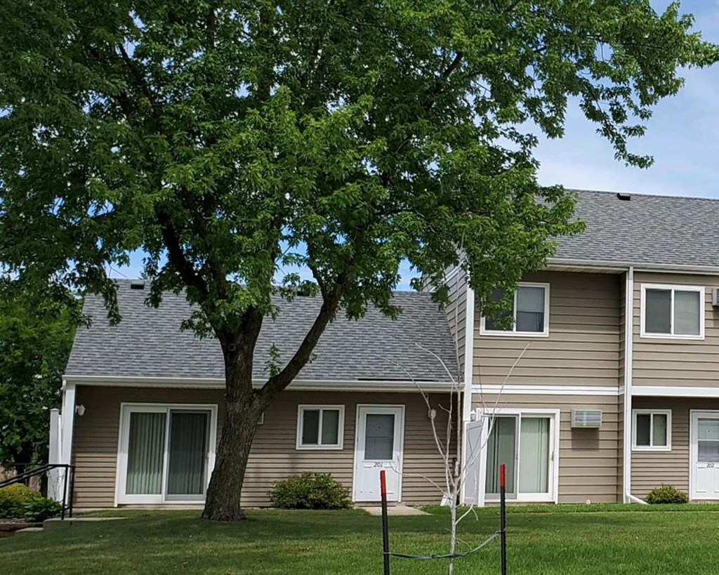 a house with a large tree in front of it