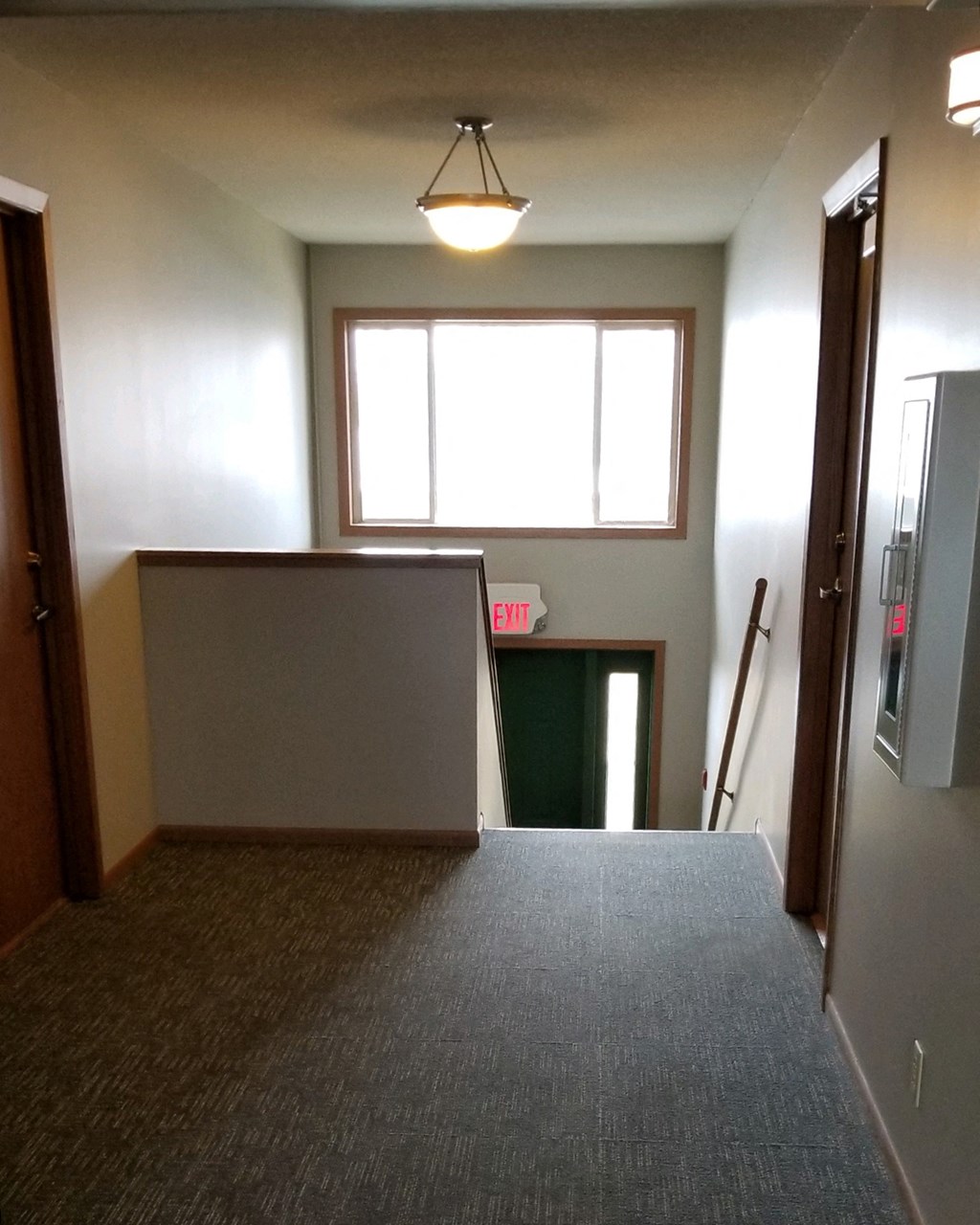 an empty room with a door and a window