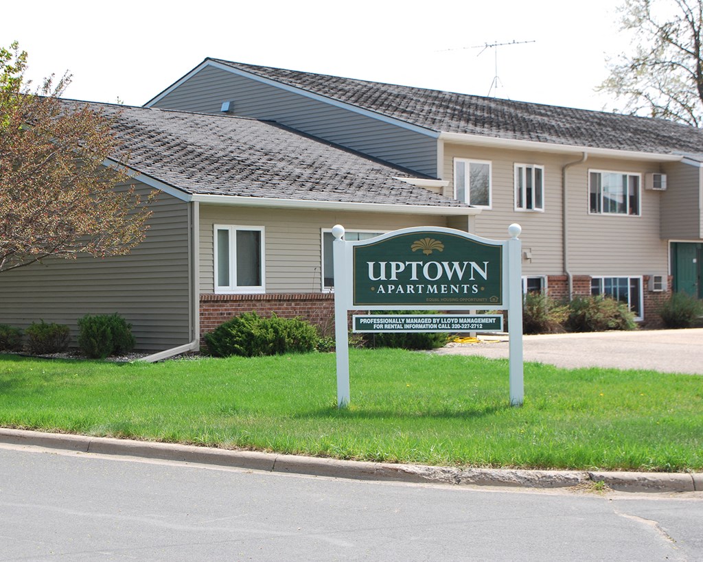 up town apartments sign in front of a building