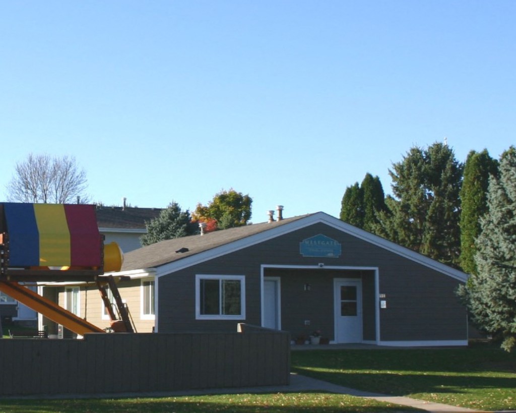 a house with a playground in front of it