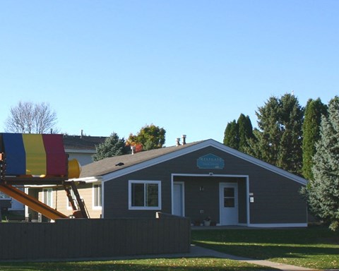 a house with a playground in front of it