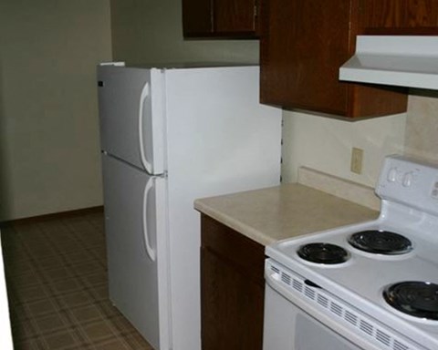 a kitchen with a stove and a refrigerator