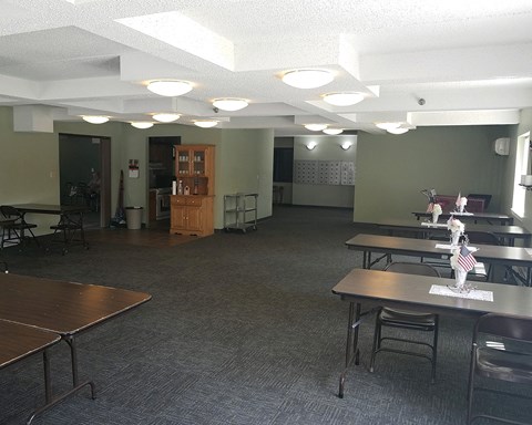 an empty room with tables and chairs in a room