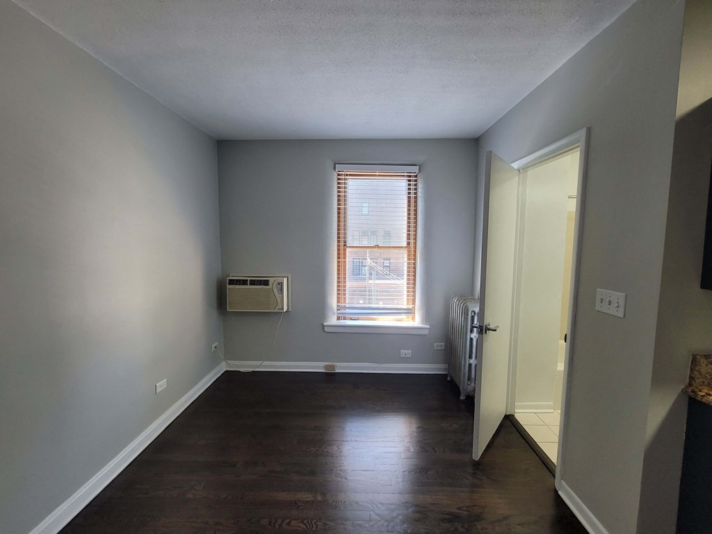 a living room with wood floors and a window